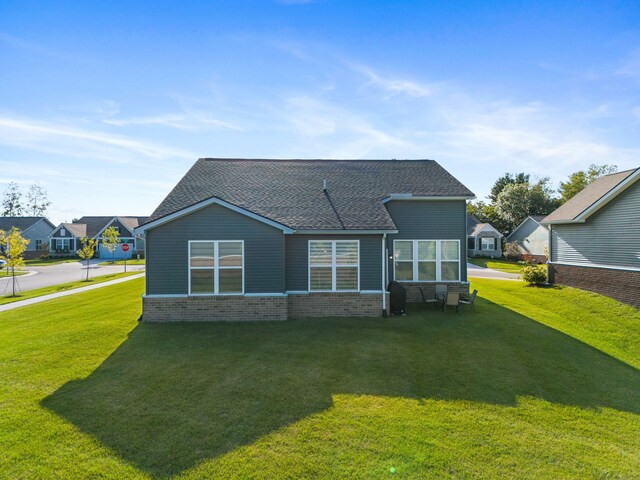 rear view of property with a yard