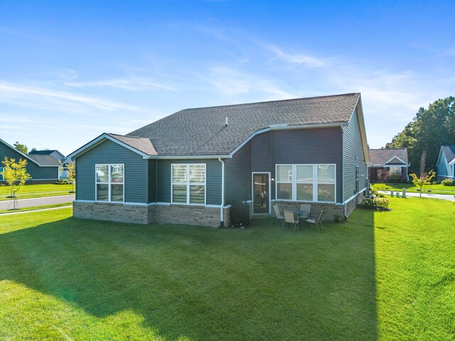 rear view of property featuring a yard