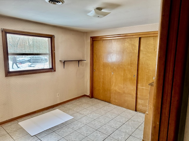 unfurnished bedroom with light tile patterned flooring