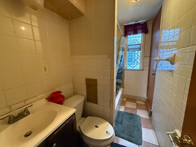 bathroom featuring toilet, tile walls, vanity, and curtained shower