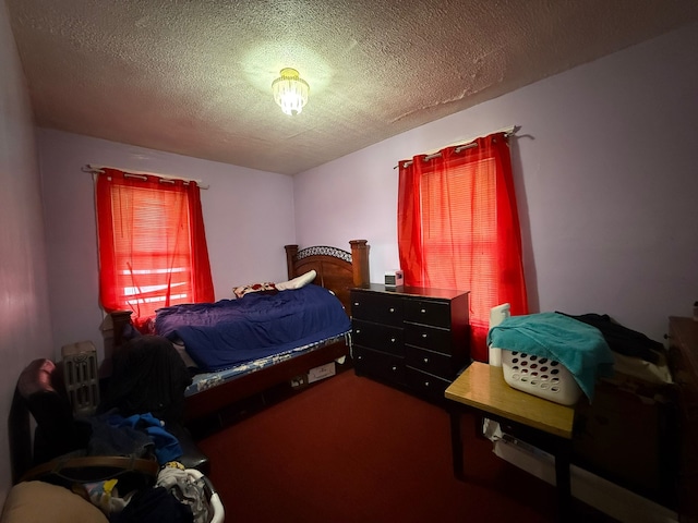 carpeted bedroom with a textured ceiling