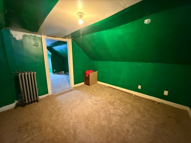 bonus room with carpet, lofted ceiling, and radiator heating unit