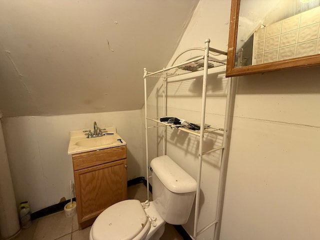 bathroom with toilet, vanity, and lofted ceiling