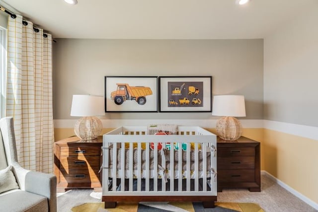 bedroom featuring light colored carpet and a crib