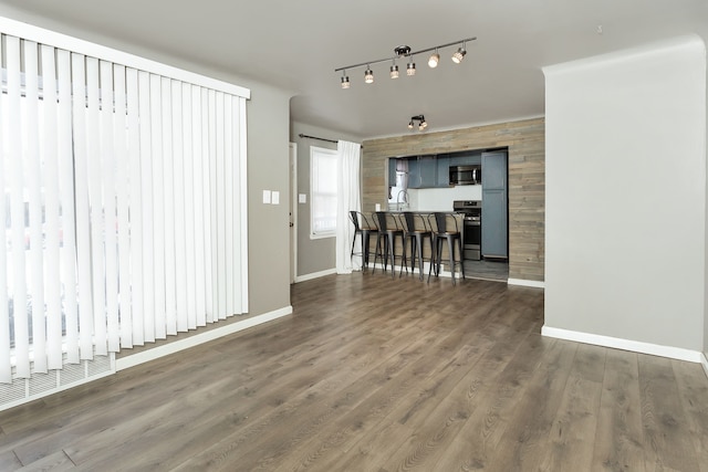 unfurnished living room featuring dark hardwood / wood-style floors and sink