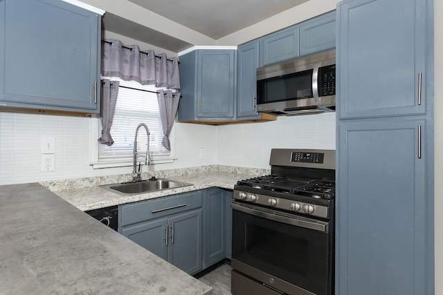 kitchen with stainless steel appliances, blue cabinetry, and sink