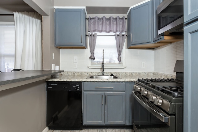 kitchen with sink, blue cabinetry, and black appliances