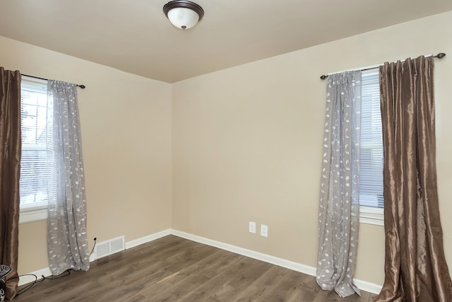 spare room featuring dark hardwood / wood-style floors