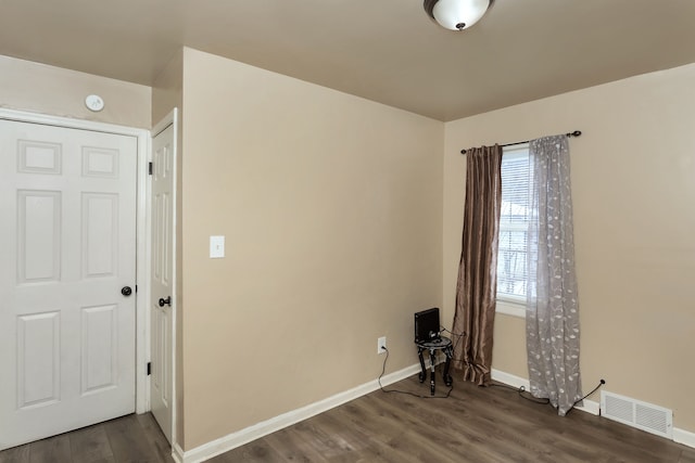 empty room with dark wood-type flooring