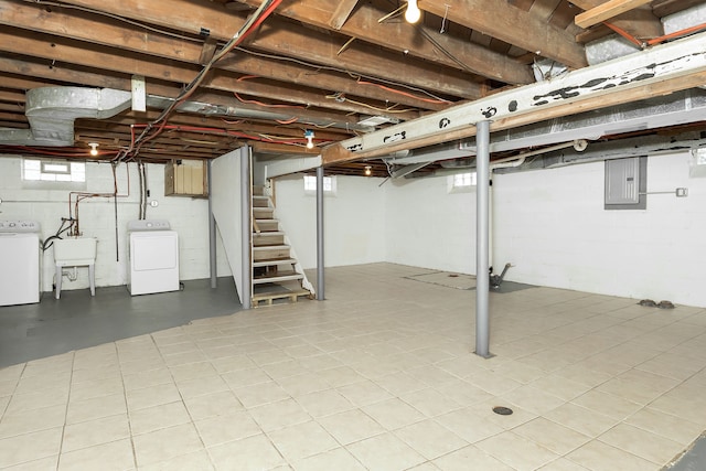 basement featuring washer / dryer, electric panel, and sink