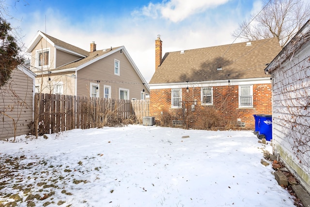 snow covered property featuring central AC