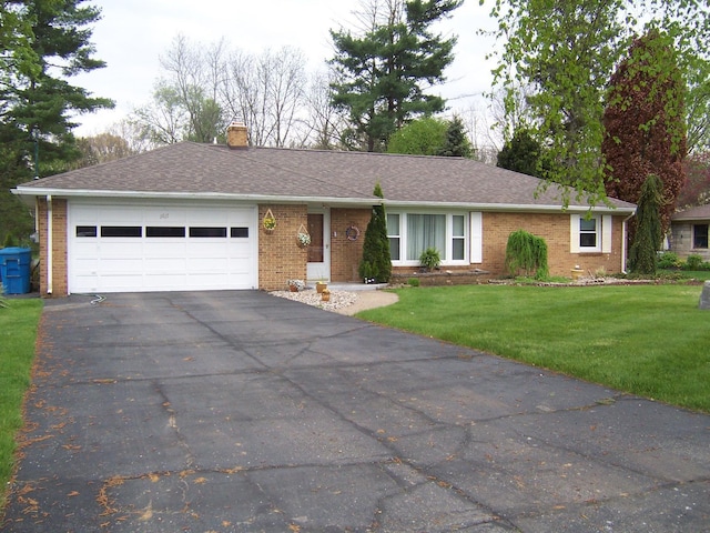 ranch-style home featuring a garage and a front yard