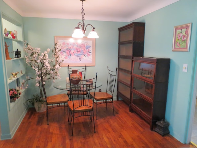 dining area featuring a chandelier and wood-type flooring