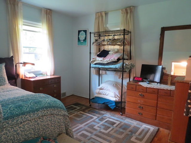 bedroom with dark hardwood / wood-style flooring