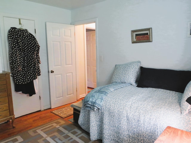 bedroom featuring dark wood-type flooring and a closet