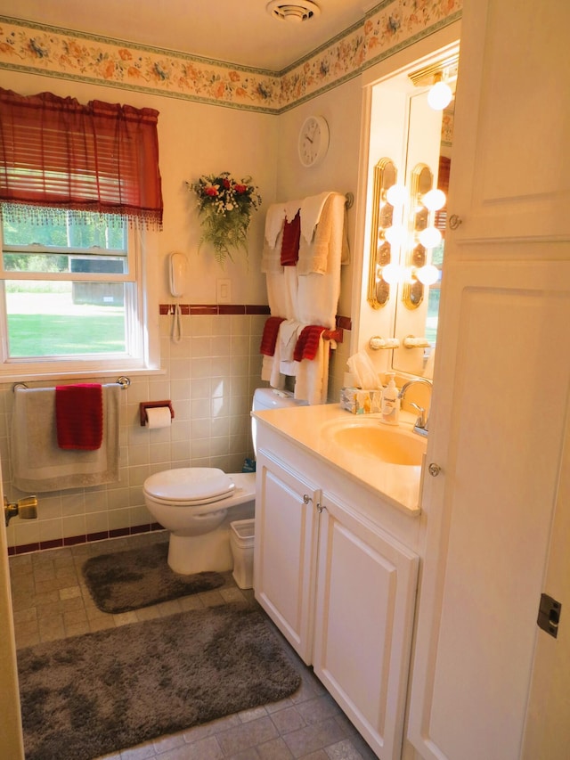 bathroom featuring tile walls, tile patterned floors, vanity, and toilet