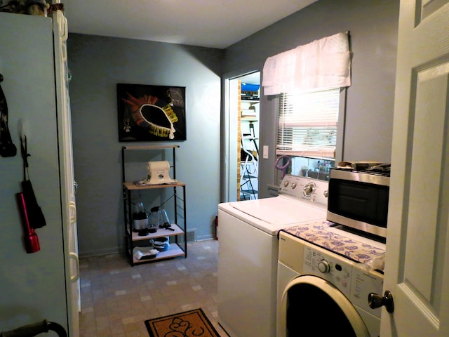 washroom featuring washer and clothes dryer