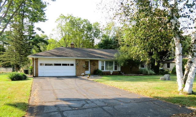 view of front of home with a front lawn and a garage