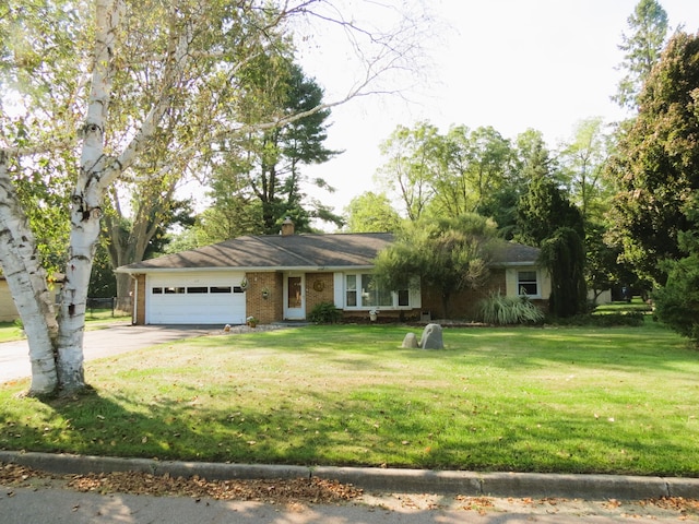 single story home featuring a front yard and a garage