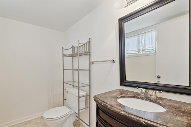 bathroom featuring tile patterned floors, toilet, and vanity