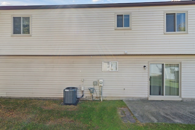 rear view of property featuring central AC and a patio