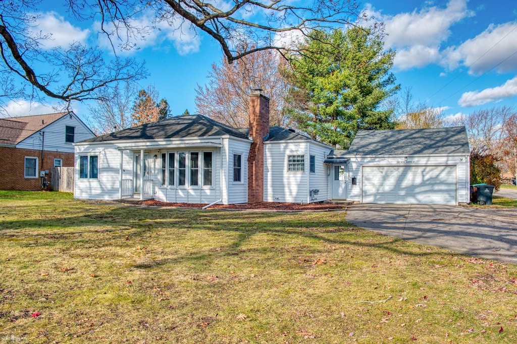 ranch-style home featuring a garage and a front yard