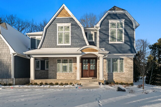 craftsman-style home featuring a porch and french doors