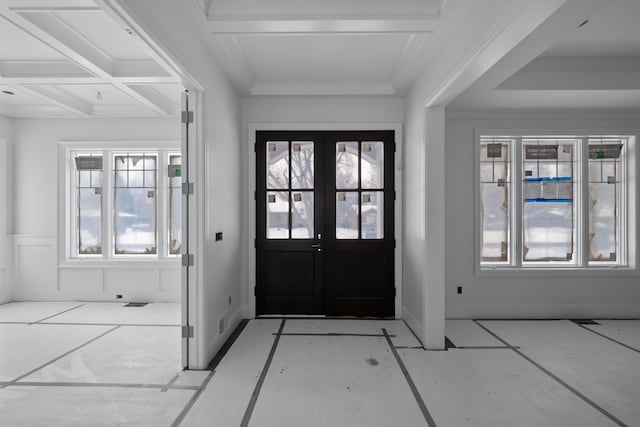 foyer entrance featuring beamed ceiling, french doors, and coffered ceiling