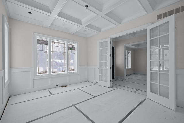 interior space featuring beam ceiling, light tile patterned floors, french doors, and coffered ceiling