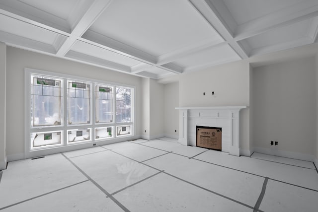 unfurnished living room featuring a wealth of natural light, coffered ceiling, and beamed ceiling