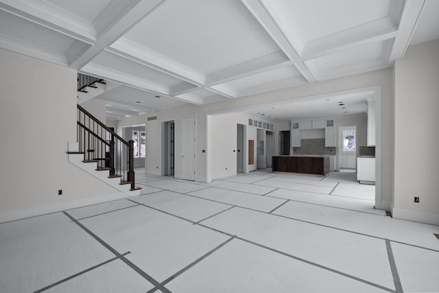 unfurnished living room featuring light tile patterned floors, beamed ceiling, and coffered ceiling