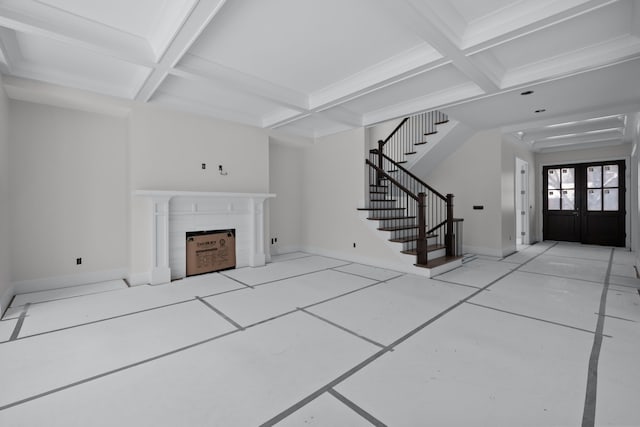 unfurnished living room with coffered ceiling, light tile patterned floors, beam ceiling, and french doors