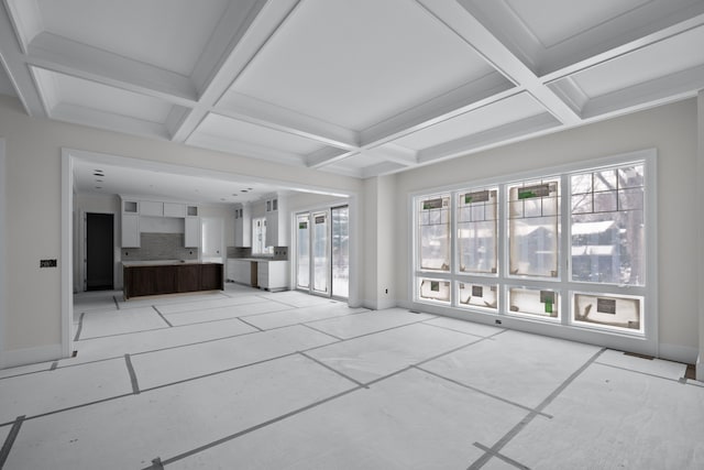 unfurnished living room with beam ceiling and coffered ceiling