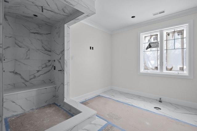 bathroom with ornamental molding and tiled shower