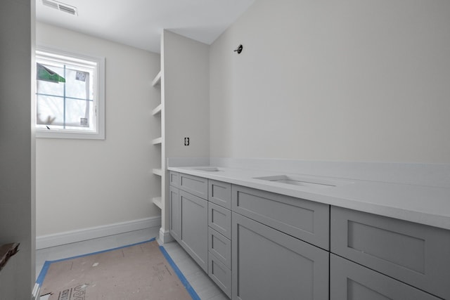 bathroom with tile patterned flooring, vanity, and built in shelves