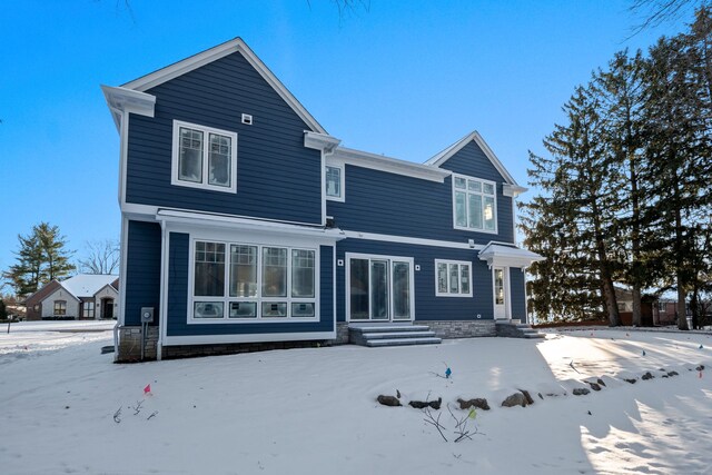 view of snow covered rear of property