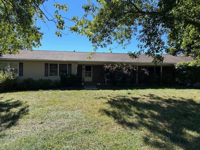 ranch-style home with a front lawn