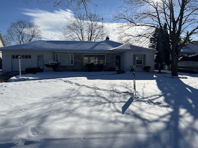 snow covered house with a garage