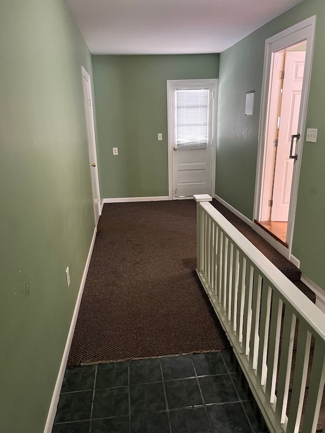 hall featuring dark colored carpet