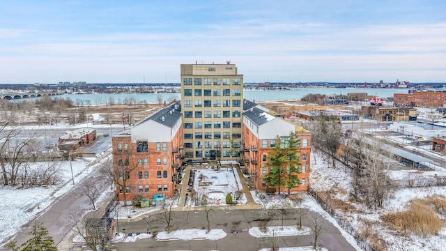 snowy aerial view featuring a water view