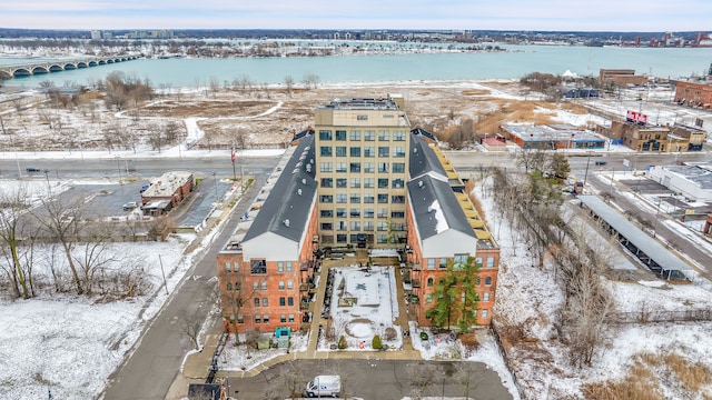 snowy aerial view with a water view