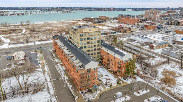 snowy aerial view with a water view