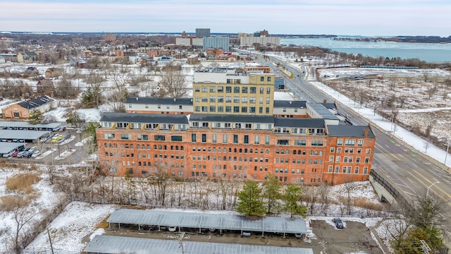 snowy aerial view with a water view