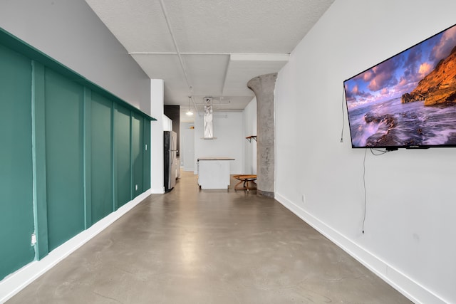 corridor with concrete flooring