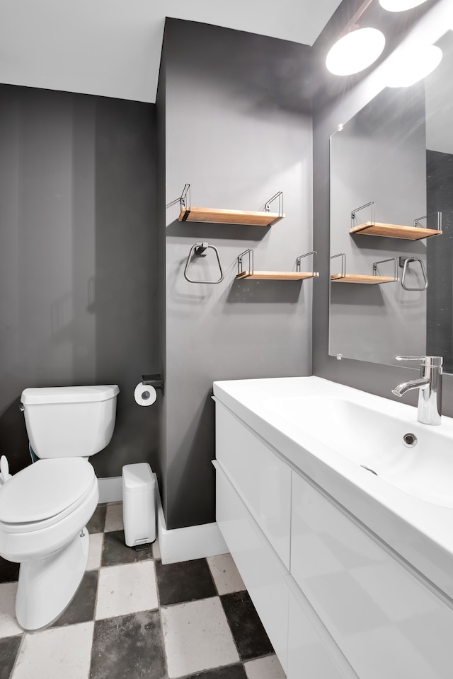 bathroom featuring toilet and vanity