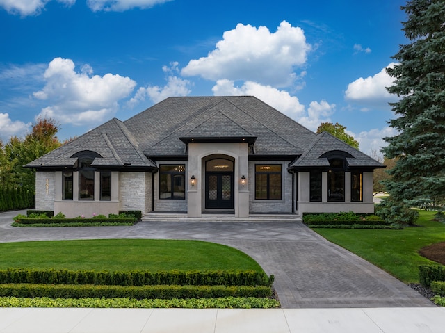 view of front of home featuring french doors and a front yard