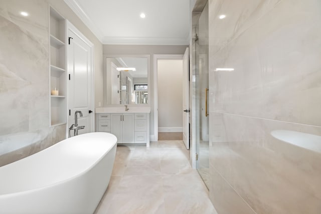 bathroom with built in features, vanity, crown molding, and a bath