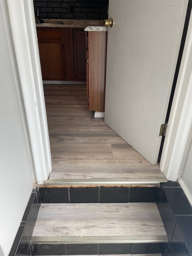 staircase featuring sink and wood-type flooring