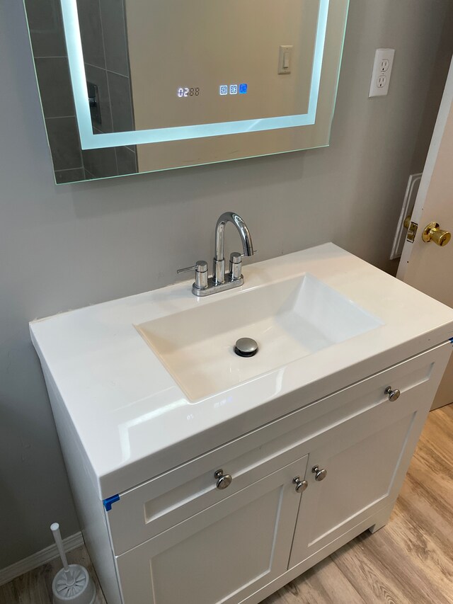 bathroom featuring hardwood / wood-style floors and vanity