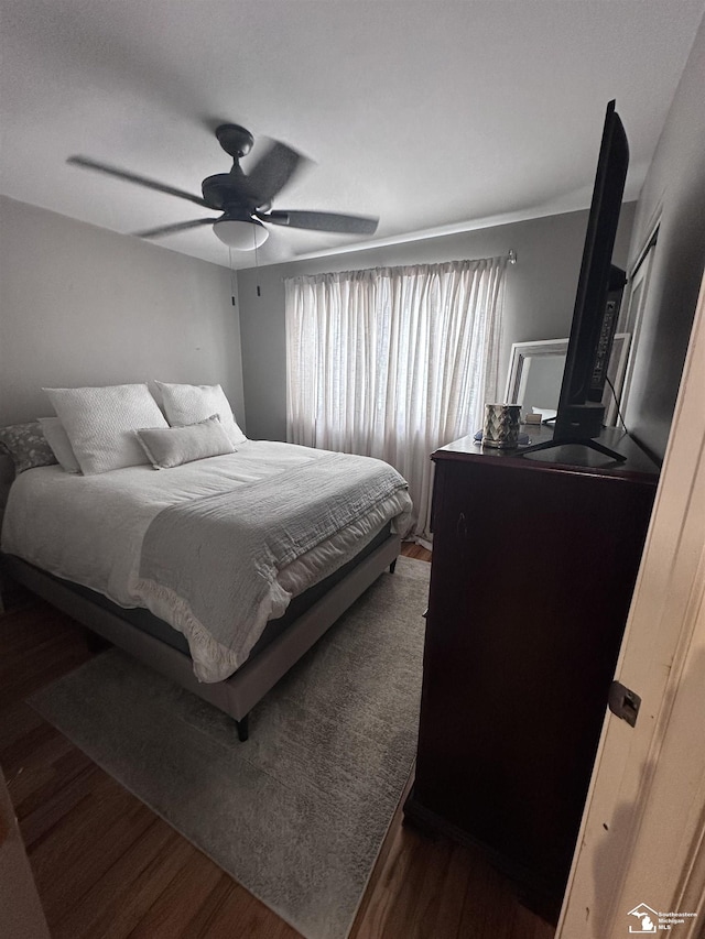 bedroom with ceiling fan and dark hardwood / wood-style floors